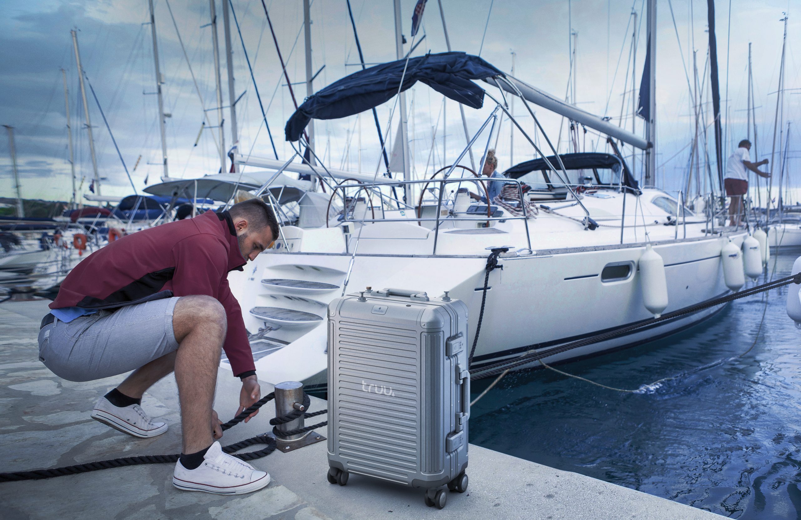 Man fixing rope on pier, Adriatic Sea